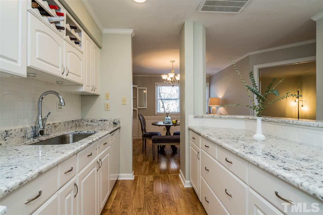 7010 Sandy Forks Road, Unit 207 Raleigh, NC 27615 - Photo 17 of 27 a kitchen with a sink and cabinets