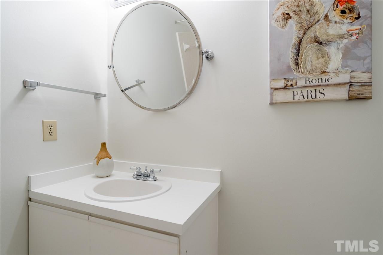 7010 Sandy Forks Road, Unit 207 Raleigh, NC 27615 - Photo 19 of 27 a bathroom with a sink and a mirror
