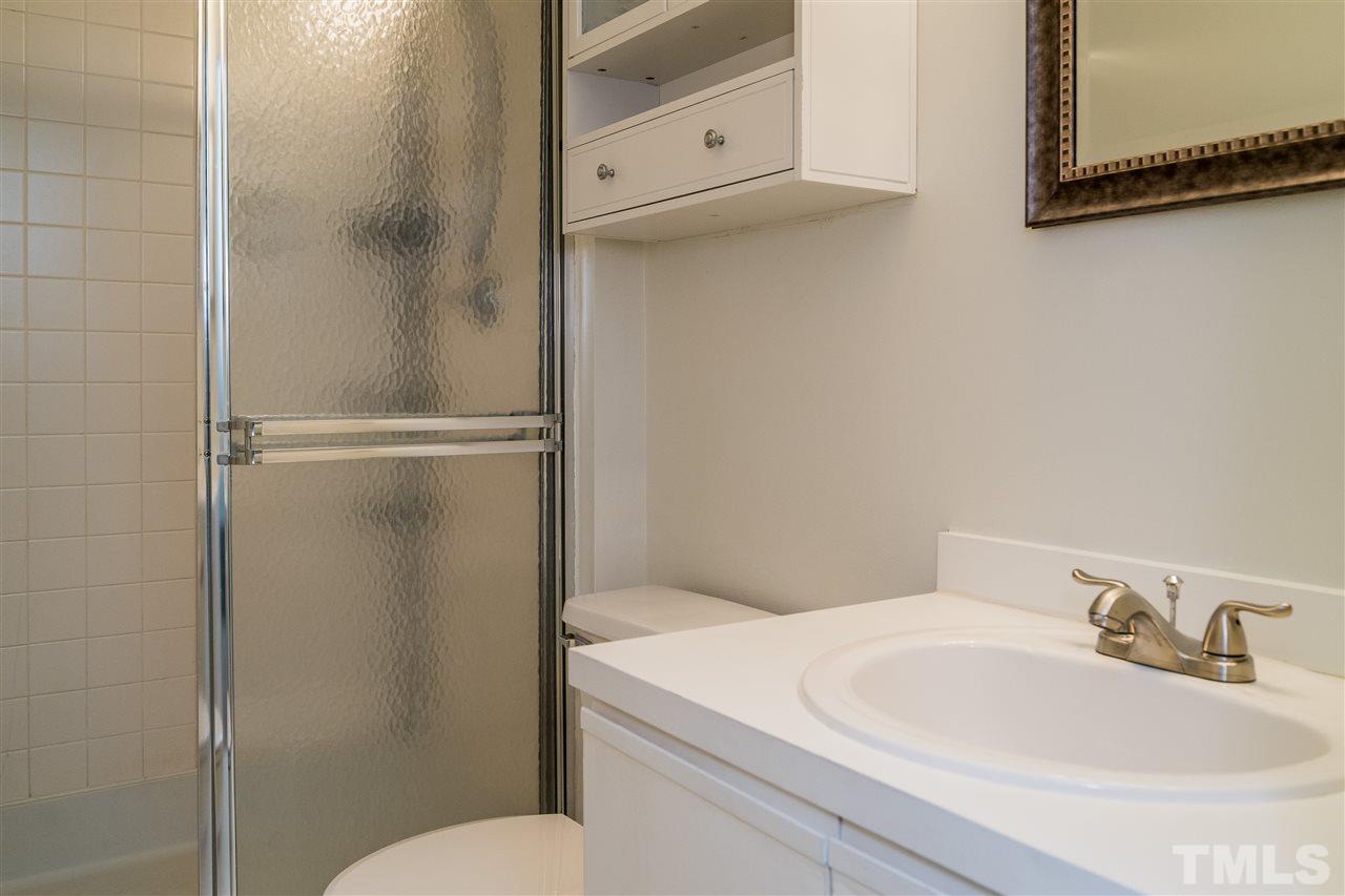 7010 Sandy Forks Road, Unit 207 Raleigh, NC 27615 - Photo 25 of 27 a bathroom with a sink and toilet