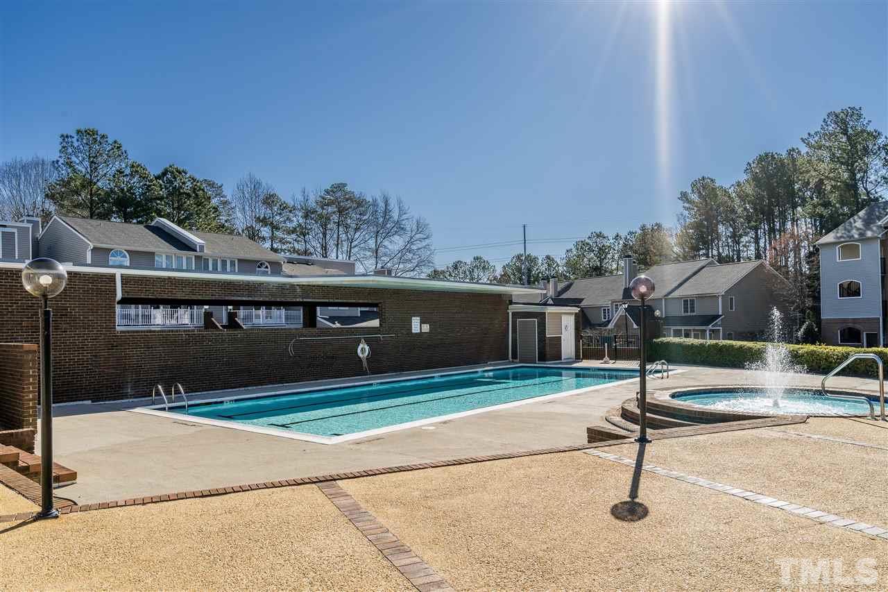 7010 Sandy Forks Road, Unit 207 Raleigh, NC 27615 - Photo 26 of 27 a view of house with swimming pool and sitting area
