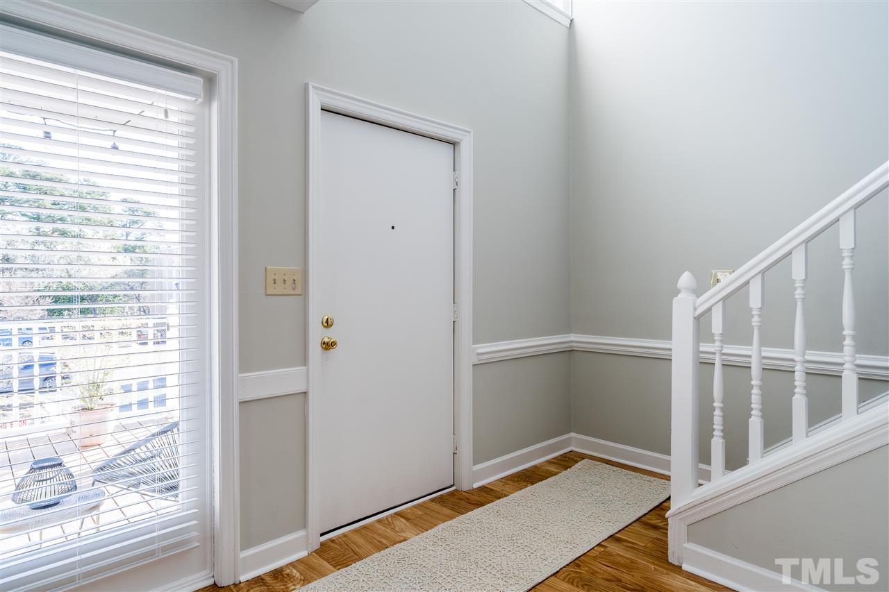7010 Sandy Forks Road, Unit 207 Raleigh, NC 27615 - Photo 5 of 27 a view of an empty room with wooden floor and a window