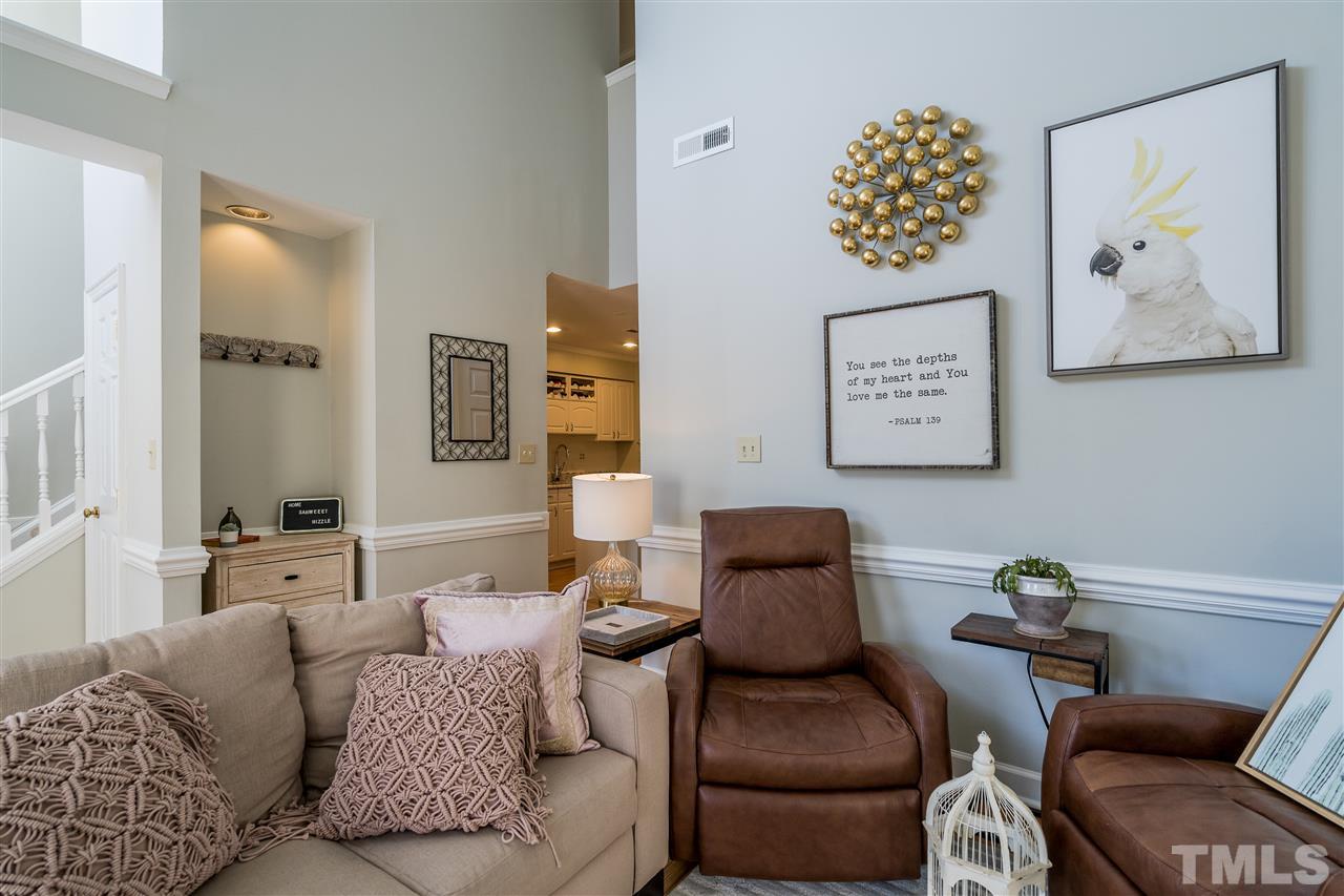 7010 Sandy Forks Road, Unit 207 Raleigh, NC 27615 - Photo 9 of 27 a living room with furniture and painting on the wall