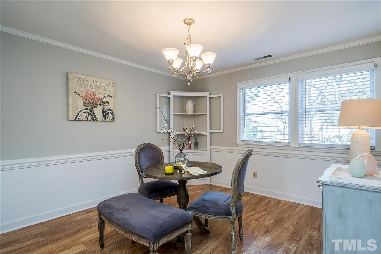 7010 Sandy Forks Road, Unit 207 Raleigh, NC 27615 - Photo 10 of 27 a view of a dining room with furniture and a chandelier