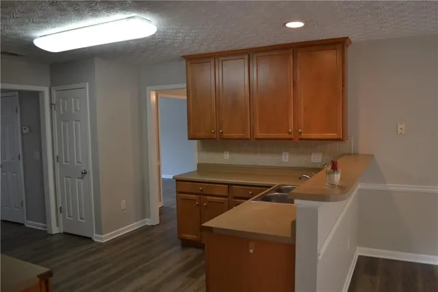 a view of a storage and utility room with wooden floor