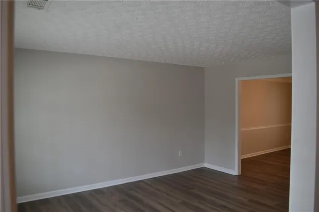 a view of an empty room and wooden floor
