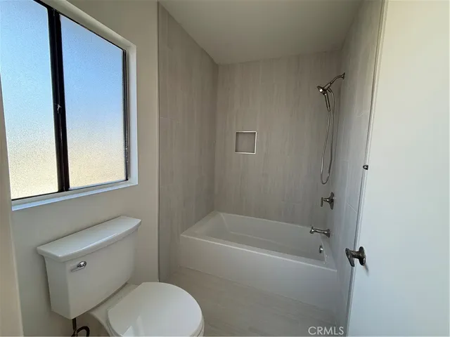 a bathroom with a toilet a sink and bathtub