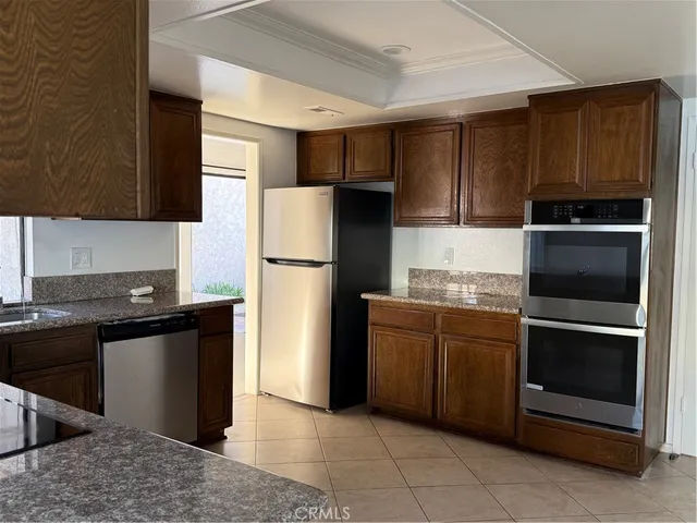 a kitchen with a refrigerator sink and stove