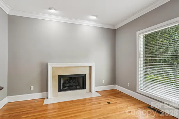 a view of a livingroom with a chandelier fan and a large window