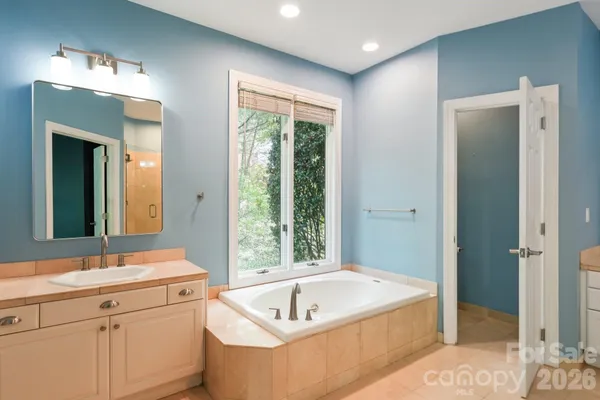 a bathroom with a granite countertop sink a toilet and shower