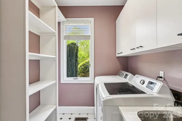 a kitchen with stainless steel appliances granite countertop a sink and a microwave