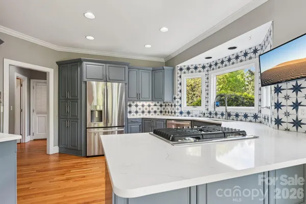a kitchen with a sink stove and window