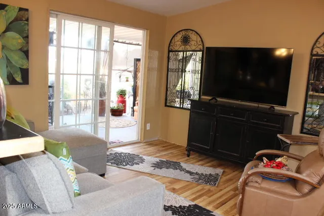 a living room with furniture and a flat screen tv