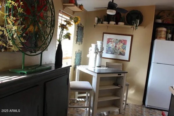 a view of a workspace room with wooden floor and furniture