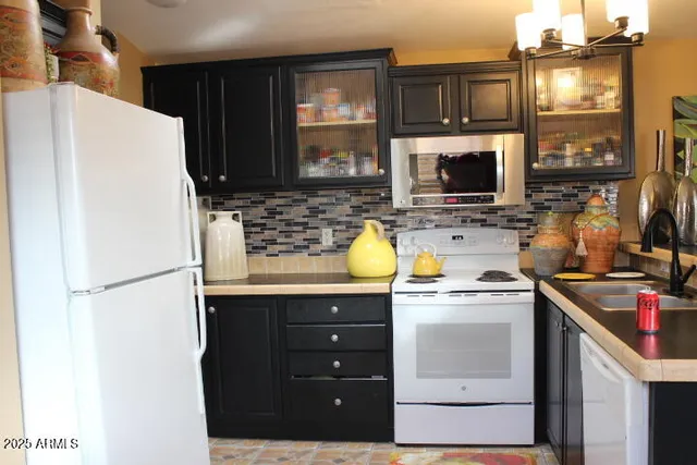 a kitchen with a sink a stove and a refrigerator