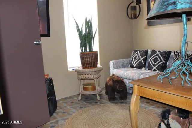 a dining room with furniture and a mirror