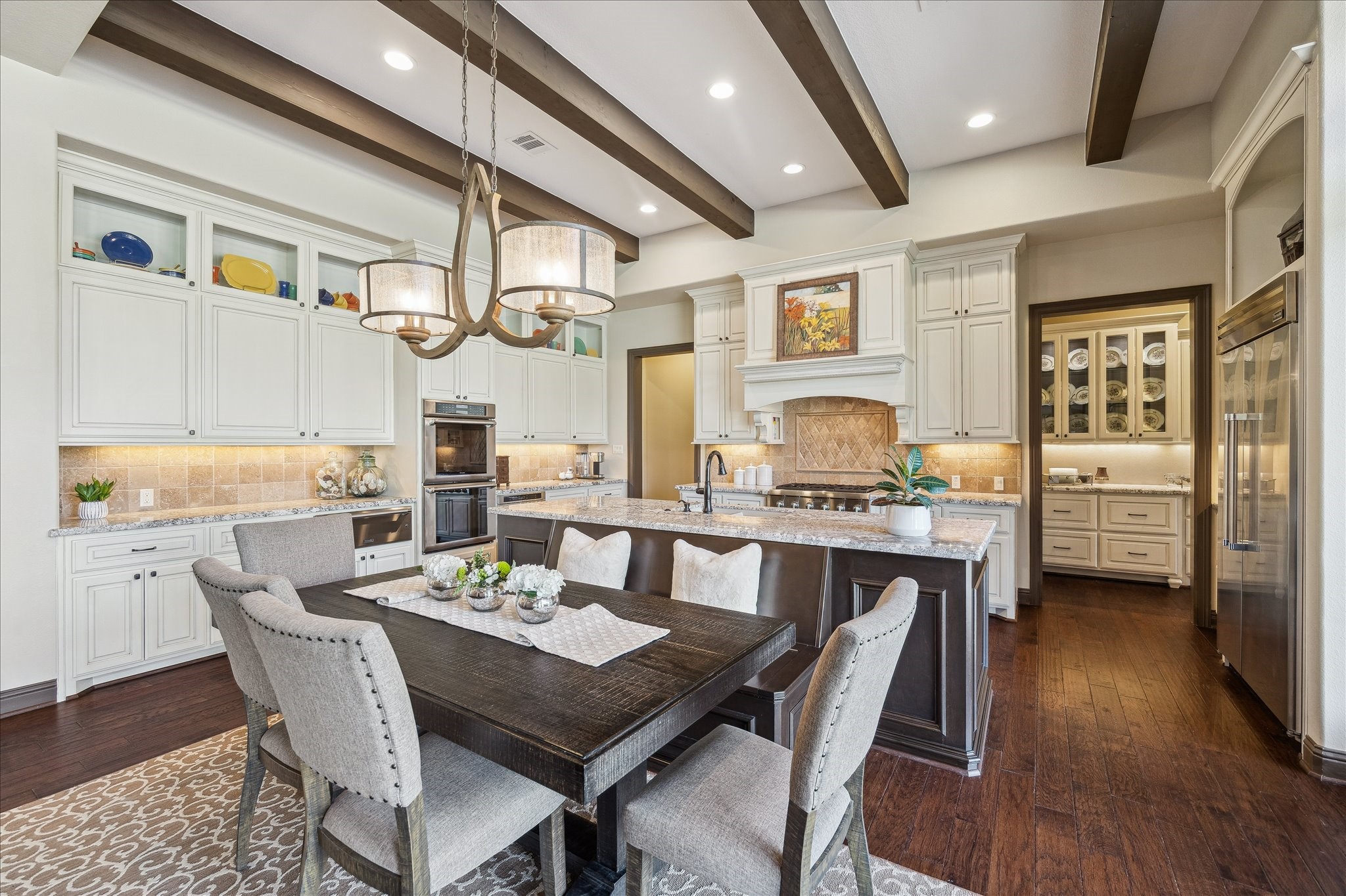 11 Willowcreek Ranch Road Tomball, TX 77377 - Photo 21 of 49 The family room opens to the breakfast area and chef’s kitchen. This area enjoys a built in banquet from which to enjoy coffee and the views from the wall of oversized windows.