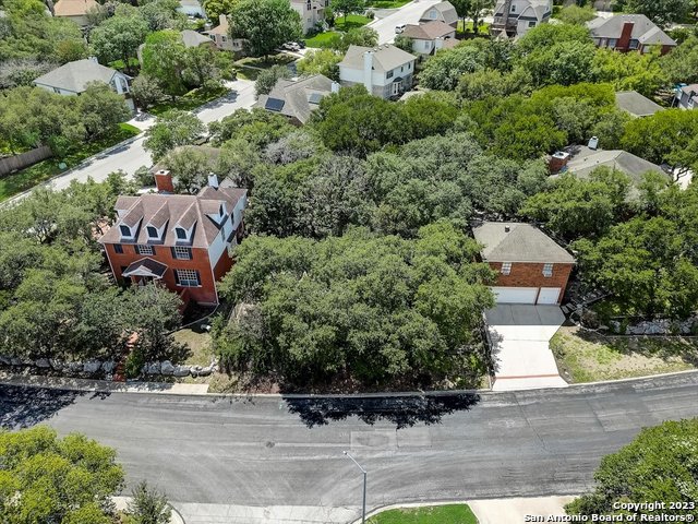 an aerial view of a house with yard and parking spaces