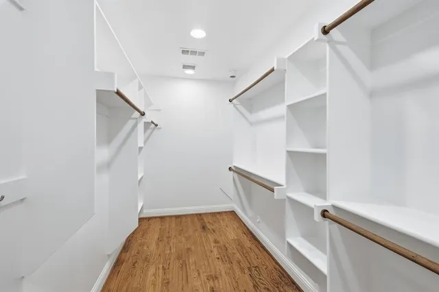 a view of hallway with stairs and wooden floor