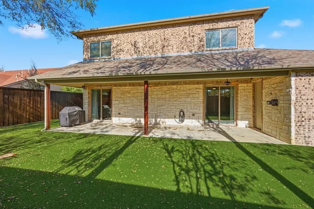 a view of a house with backyard porch and furniture