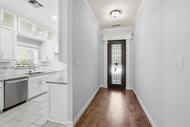 a kitchen with granite countertop a sink stove and cabinets