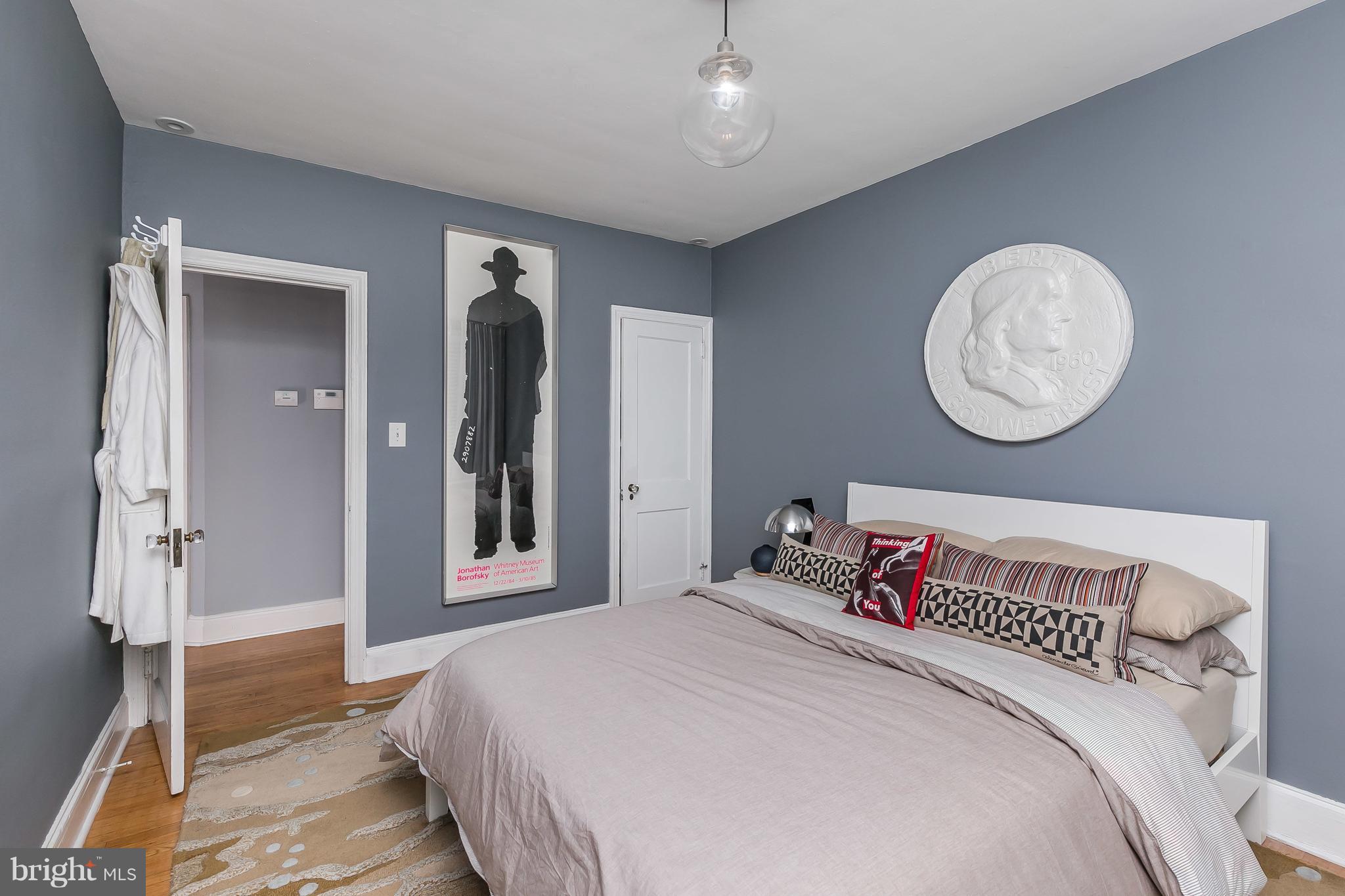 3622 Kimble Road Baltimore, MD 21218 - Photo 20 of 30 a bedroom with a large bed and a chandelier