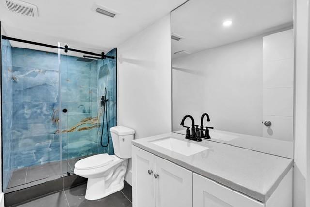 3305 Spanish Wells Drive, Unit 41B Delray Beach, FL 33445 - Photo 13 of 13 a bathroom with a sink a toilet and shower