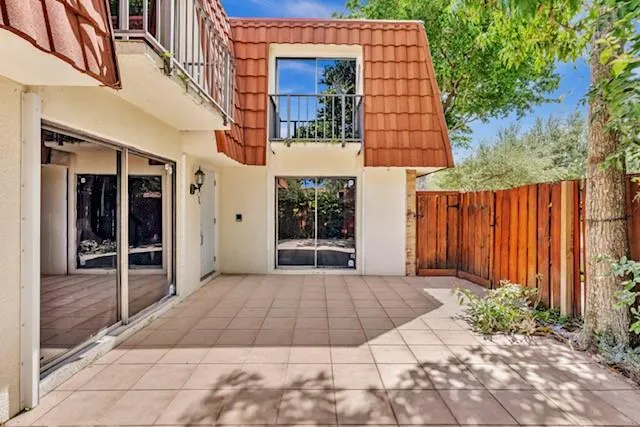 a view of a brick house with many windows and yard