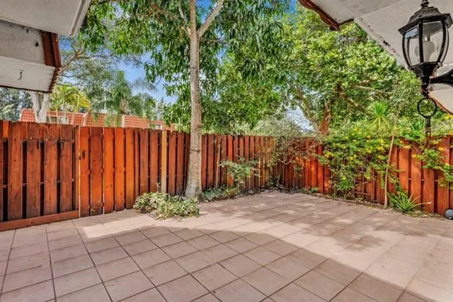 a view of a backyard with wooden fence