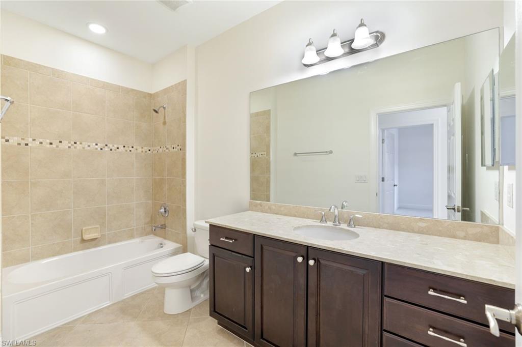 13366 Kent Street Naples, FL 34109 - Photo 15 of 23 Bathroom featuring shower combination, light tile patterned flooring, vanity, and recessed lighting