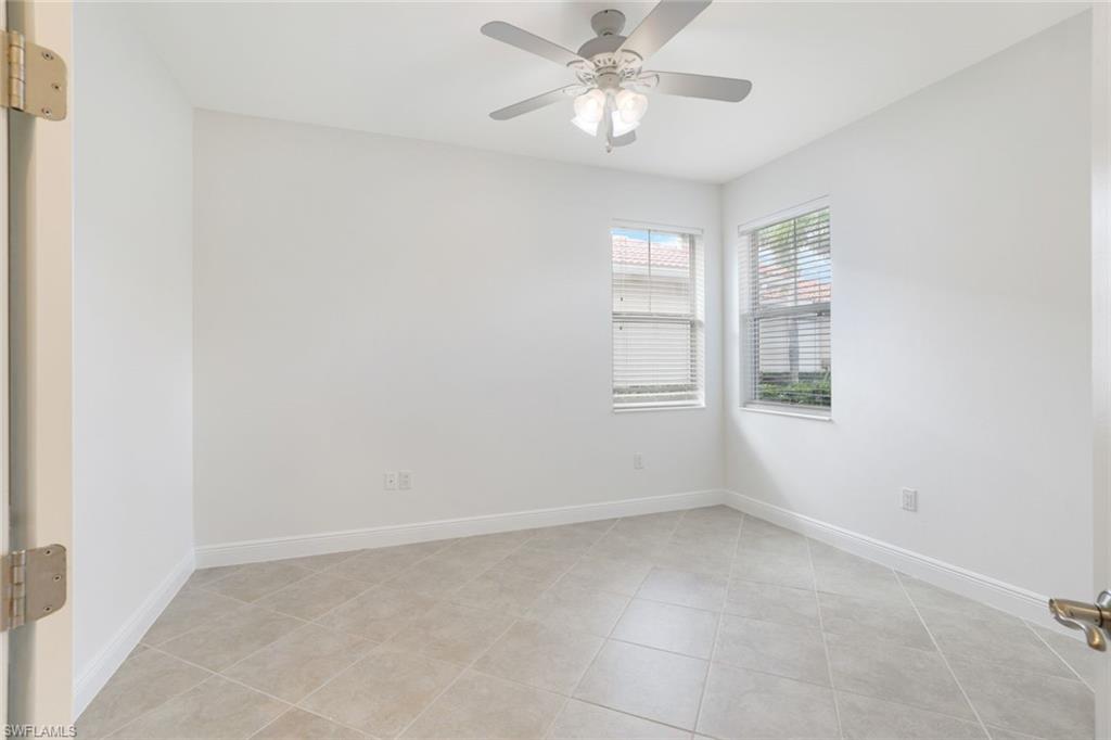 13366 Kent Street Naples, FL 34109 - Photo 16 of 23 Empty room with light tile patterned flooring and ceiling fan