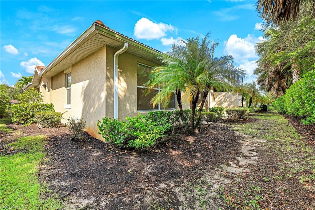 13366 Kent Street Naples, FL 34109 - Photo 19 of 23 View of side of home with stucco siding