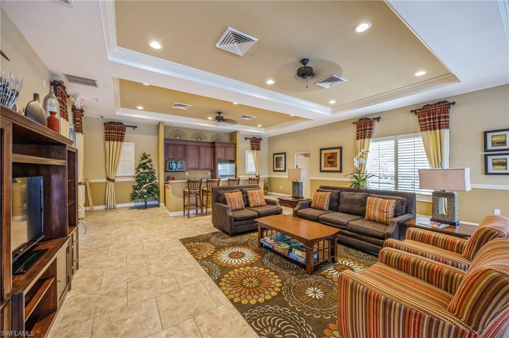 13366 Kent Street Naples, FL 34109 - Photo 21 of 23 Living room with a raised ceiling, a ceiling fan, crown molding, and recessed lighting