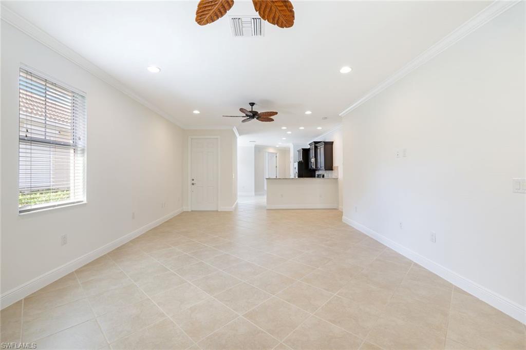 13366 Kent Street Naples, FL 34109 - Photo 8 of 23 Unfurnished living room with crown molding, recessed lighting, light tile patterned floors, and ceiling fan