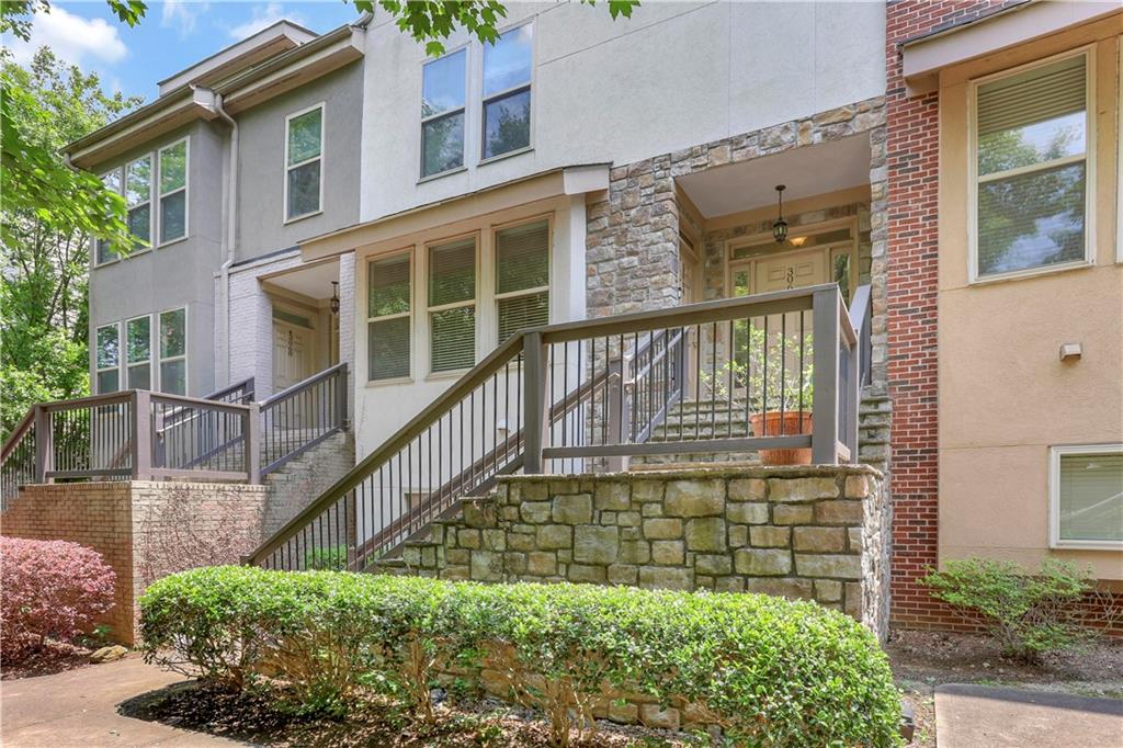 a view of a brick house with a small yard