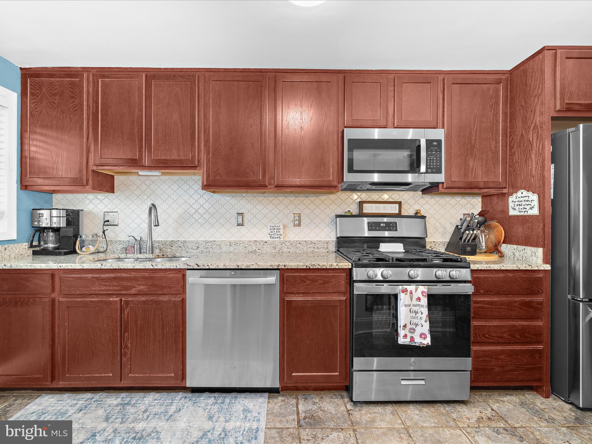 7851 Kentley Road Baltimore, MD 21222 - Photo 13 of 58 a kitchen with granite countertop wooden cabinets and stainless steel appliances