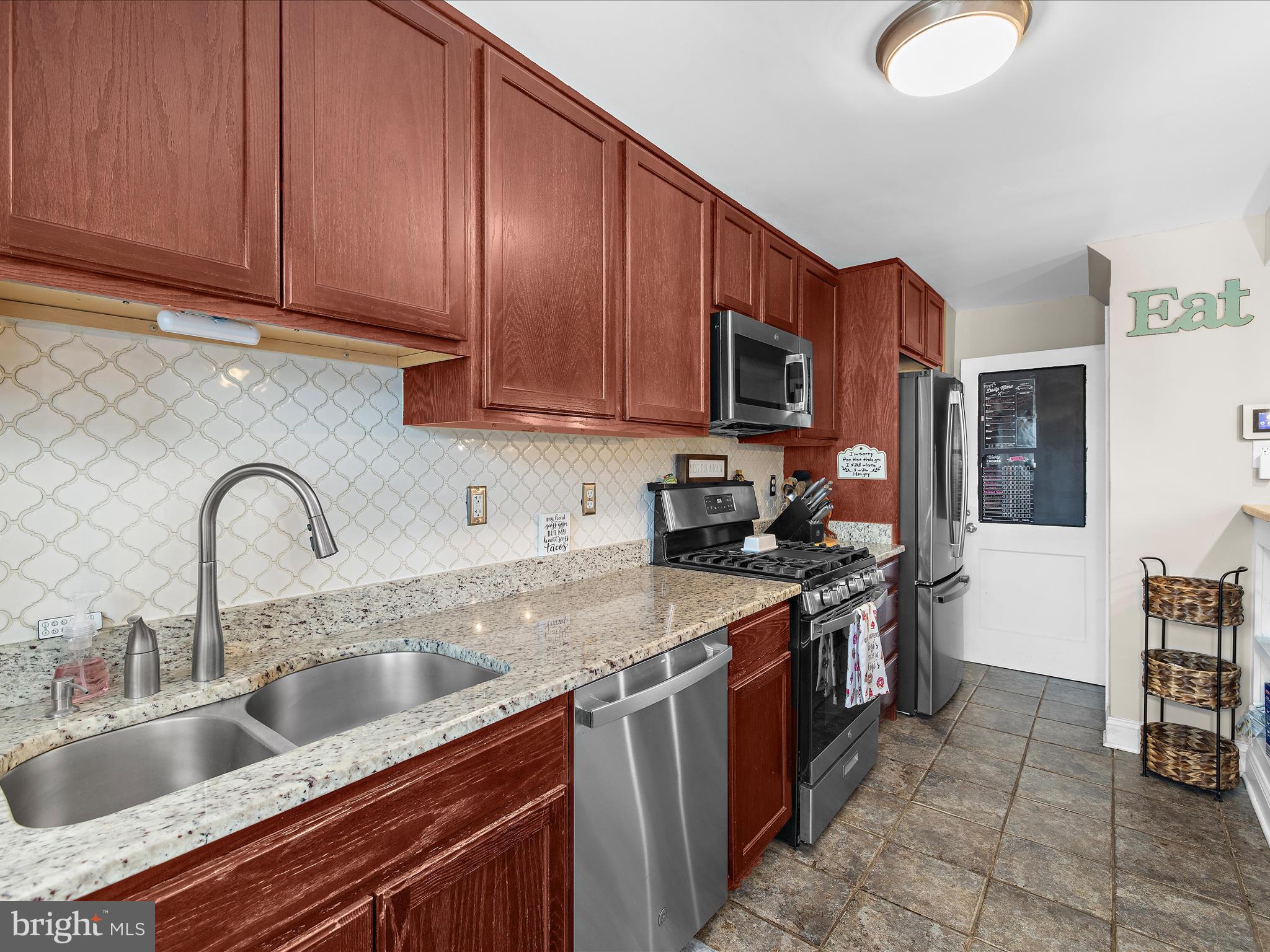 7851 Kentley Road Baltimore, MD 21222 - Photo 14 of 58 a kitchen with stainless steel appliances granite countertop a sink stove and refrigerator