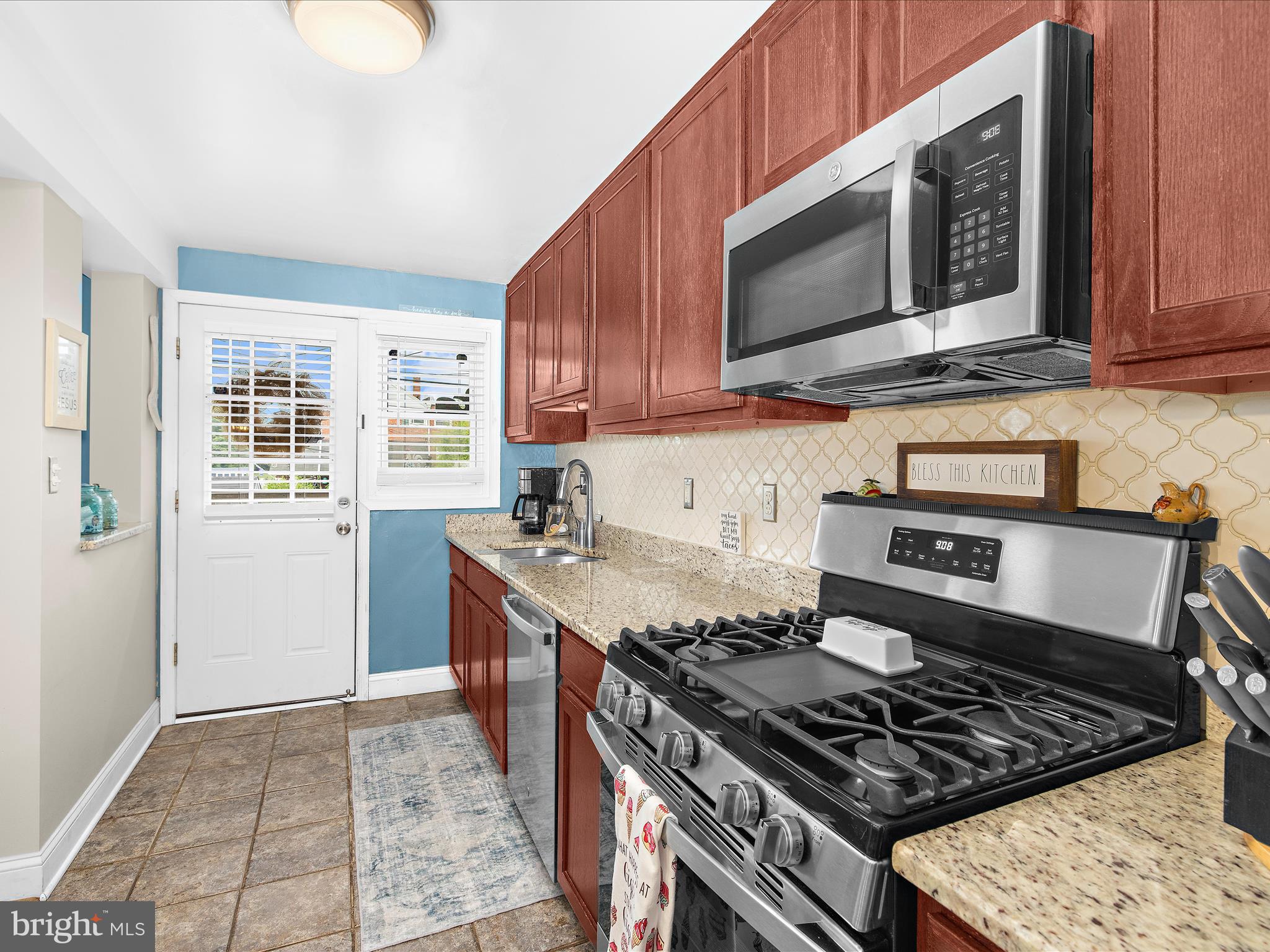 7851 Kentley Road Baltimore, MD 21222 - Photo 16 of 58 a kitchen with stainless steel appliances granite countertop a stove and a microwave