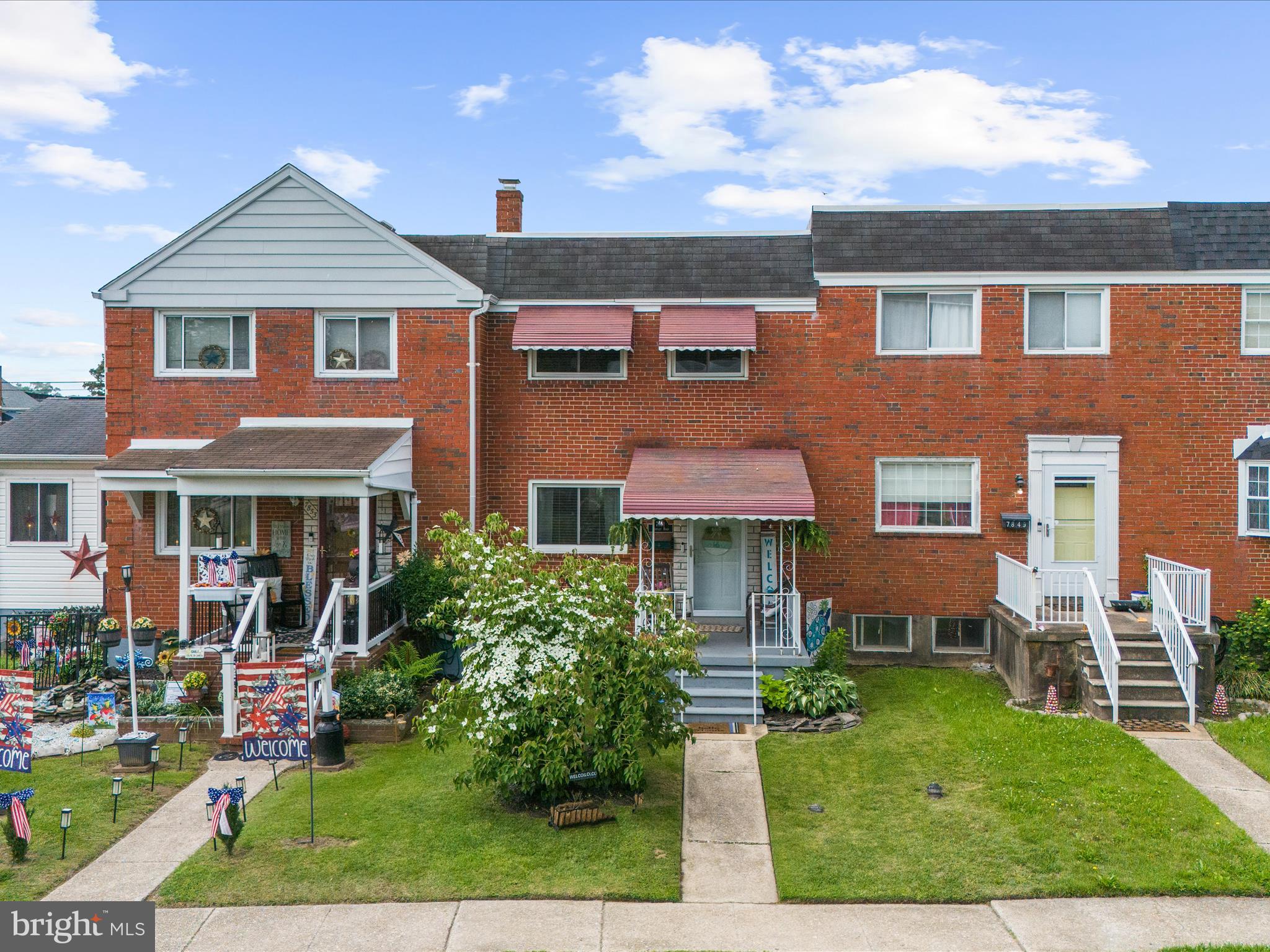 7851 Kentley Road Baltimore, MD 21222 - Photo 2 of 58 front view of a brick house with a yard