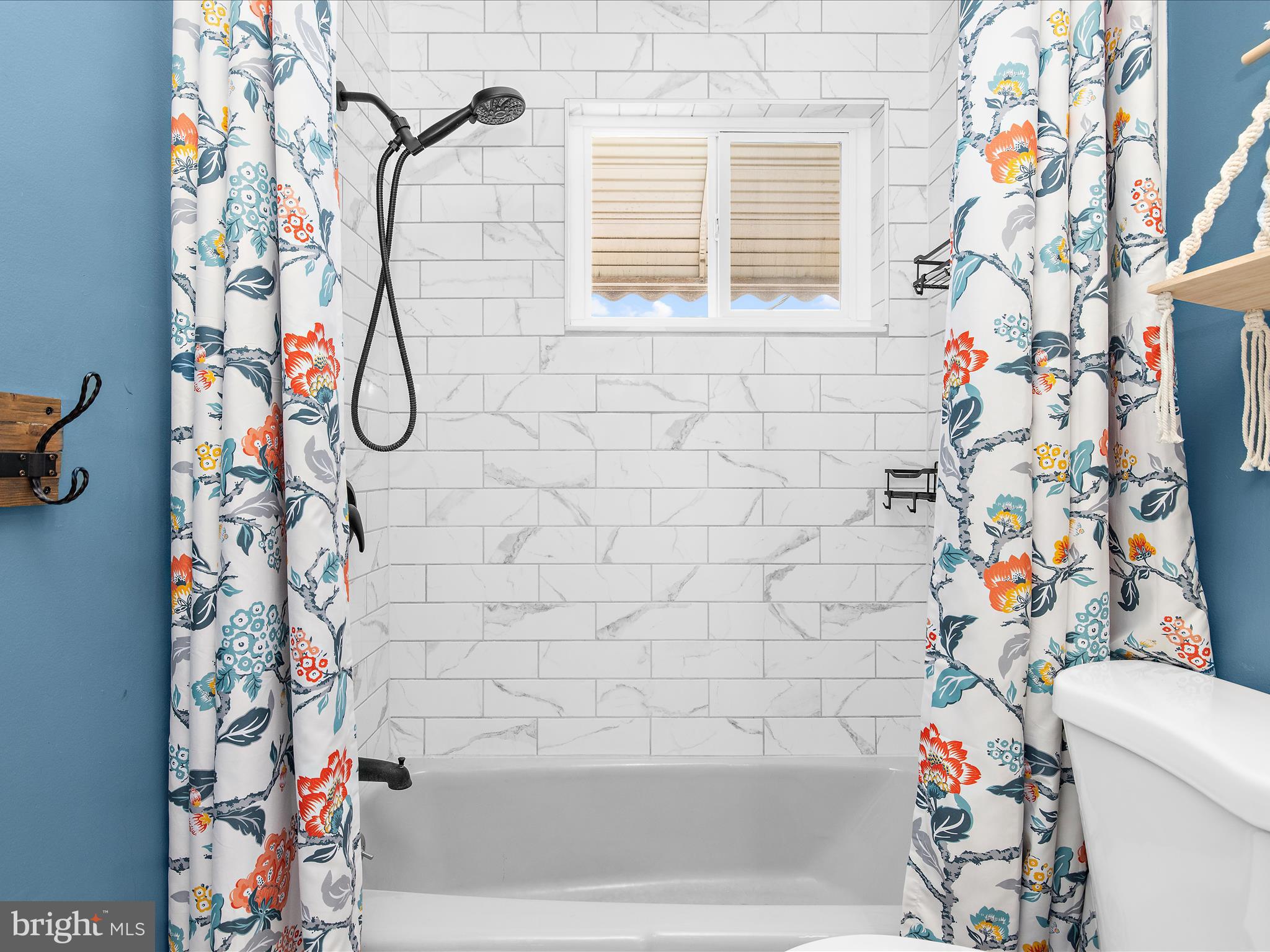 7851 Kentley Road Baltimore, MD 21222 - Photo 28 of 58 a bathroom with a shower curtain that has a shower curtain