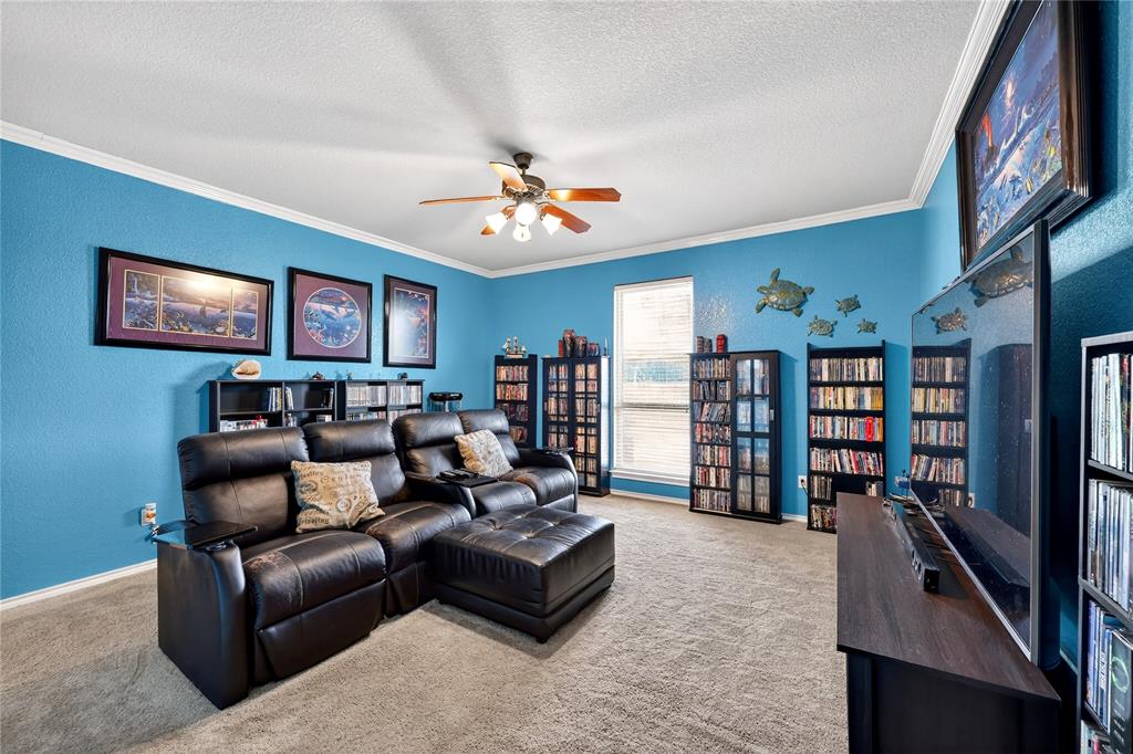1035 Highland Road Cleburne, TX 76033 - Photo 25 of 36 a living room with furniture and a bookshelf
