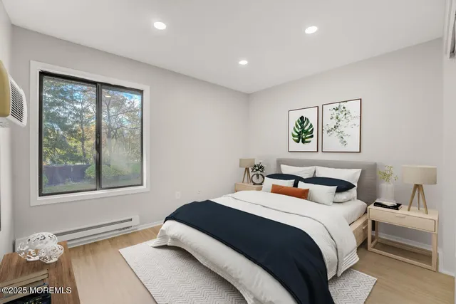 a bedroom with a bed and a painting on the wall