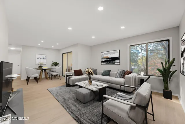 a living room with furniture wooden floor and a flat screen tv