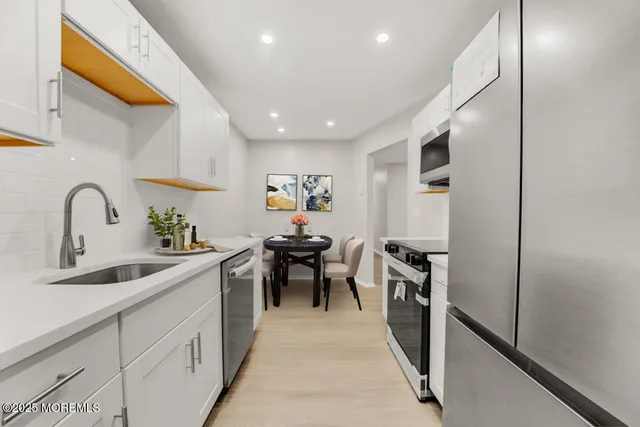 a kitchen with sink cabinets and stainless steel appliances