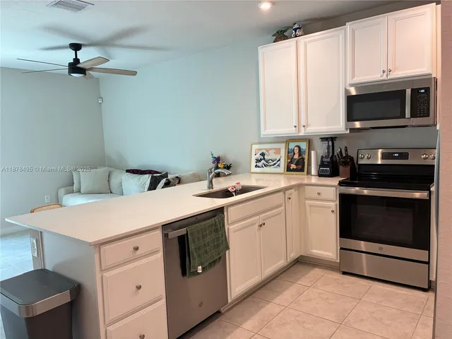 a kitchen with a sink a stove and microwave