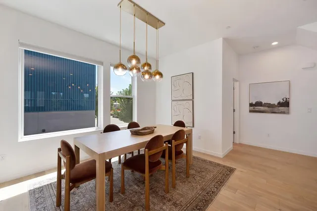 a view of a dining room with furniture and chandelier