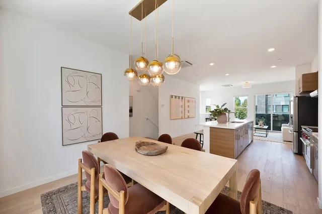 a large white kitchen with a large counter top appliances and cabinets