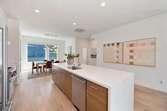 a kitchen with stainless steel appliances granite countertop a stove and a refrigerator