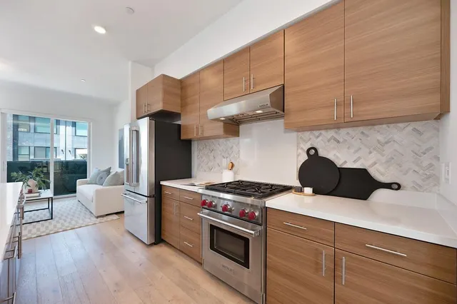 a living room with furniture and kitchen view