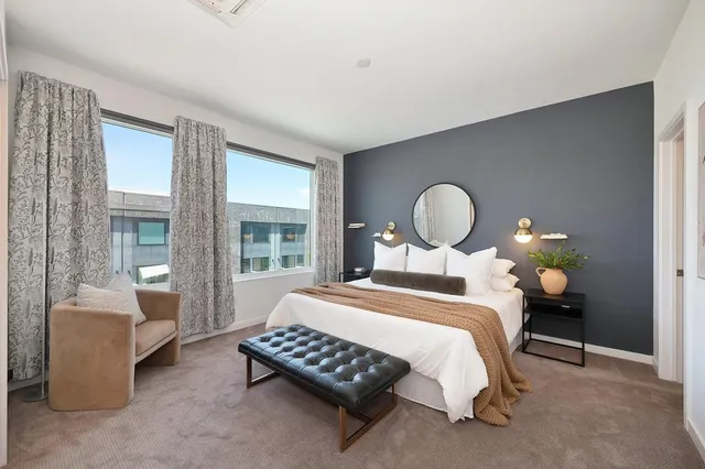 a bedroom with a large bed and a window