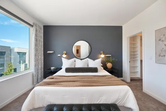 a bedroom with a large bed and a window